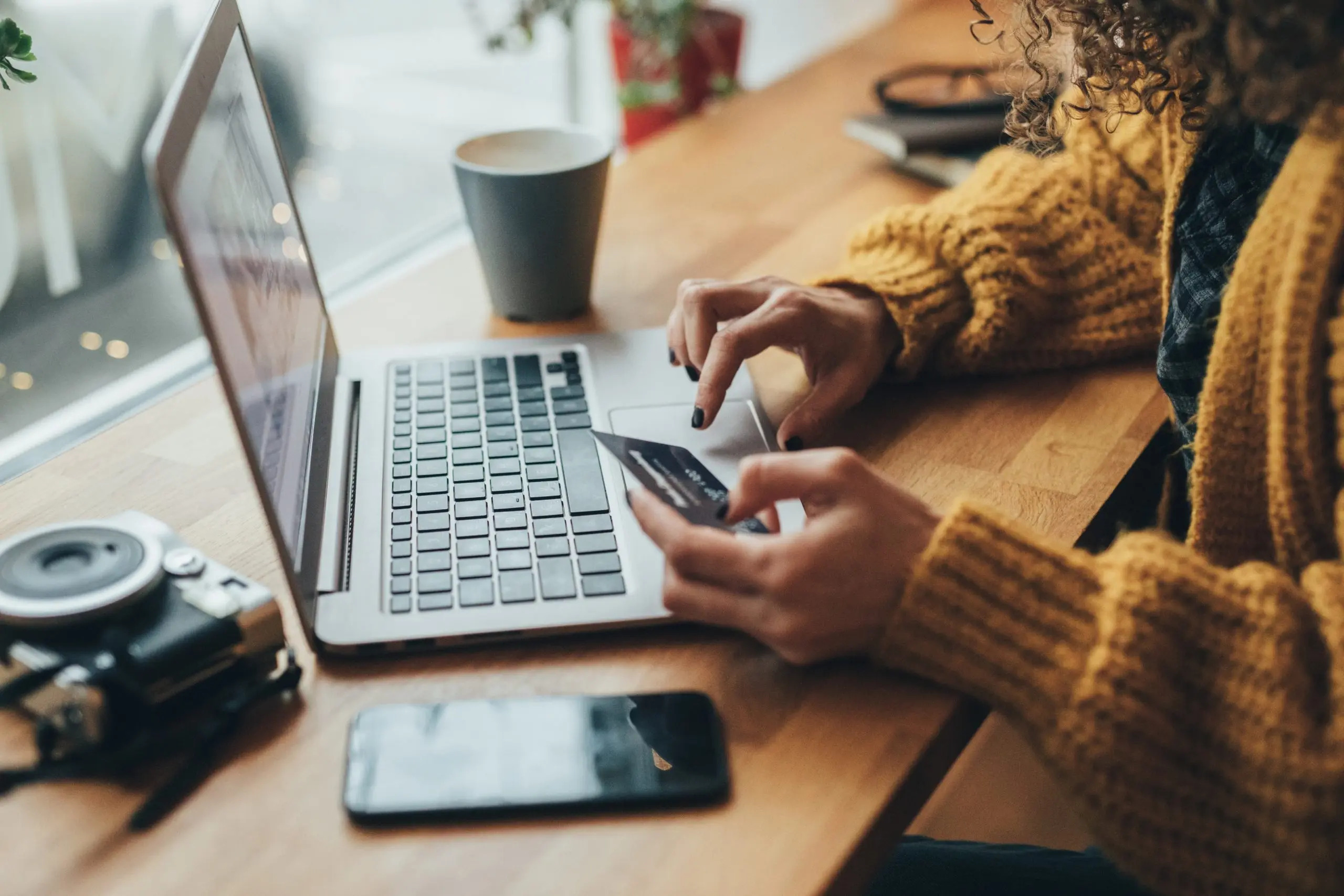 person entering credit card information on a laptop