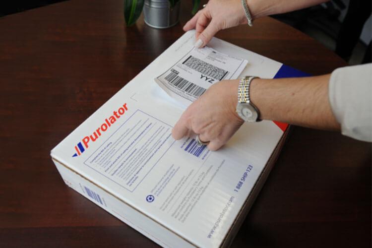 Applying Purolator label to box