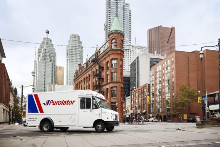 Purolator in front of buildings