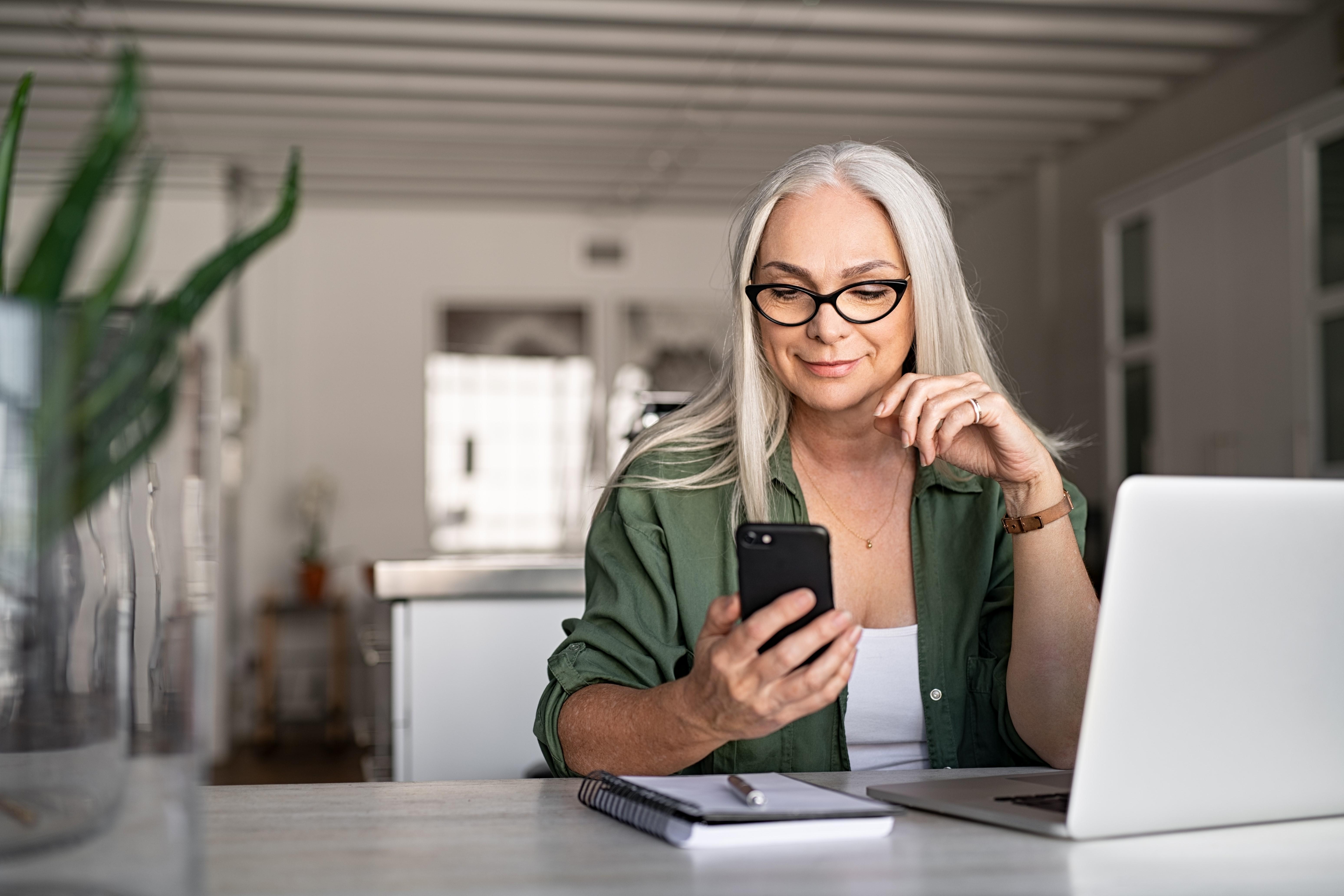 Woman on phone and laptop