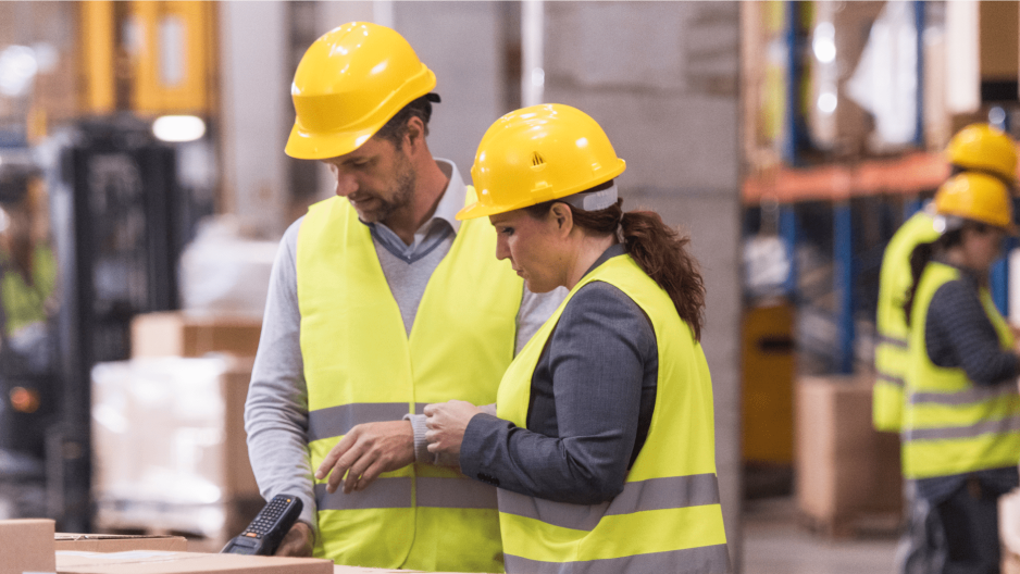 Two employees scanning auto parts