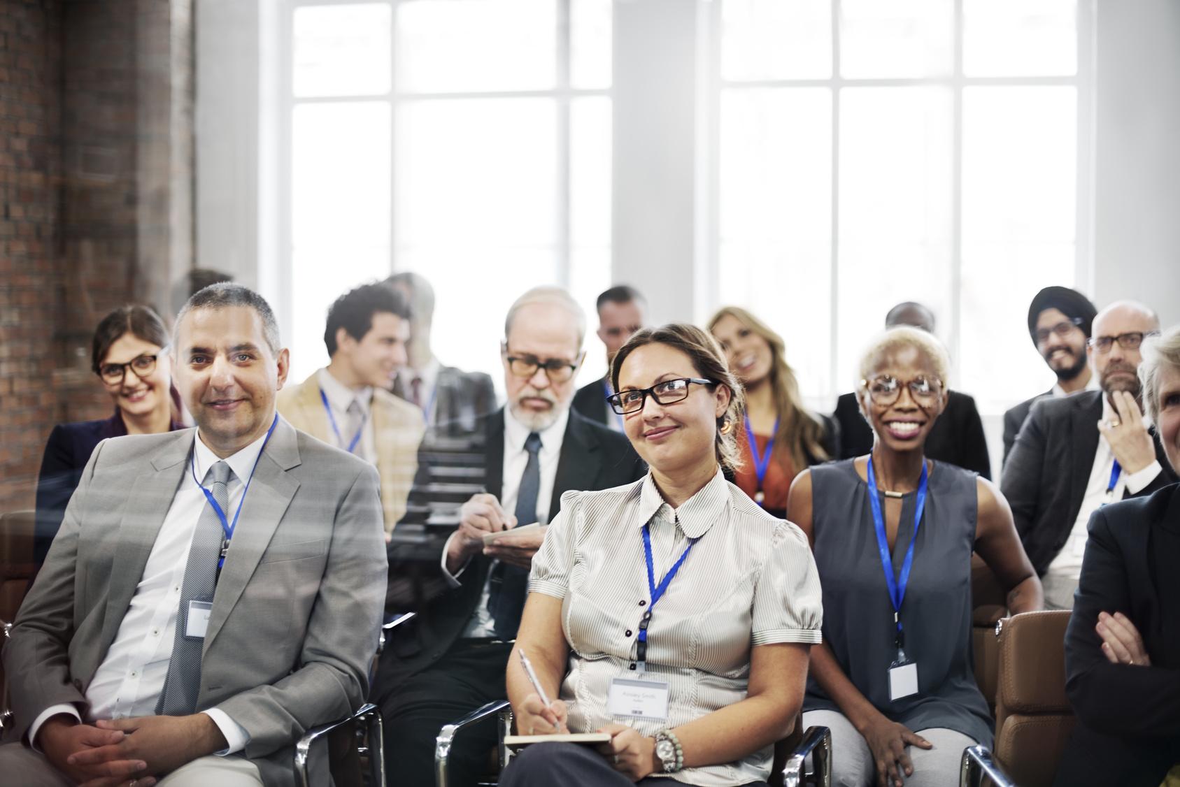 group of business people sitting down and listening