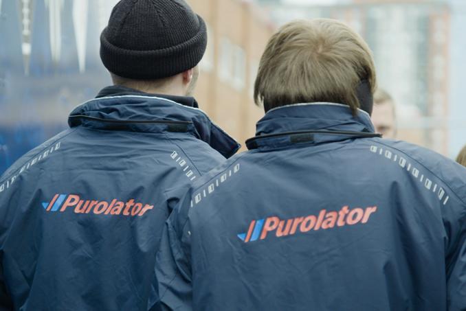 2 people wearing Purolator jackets