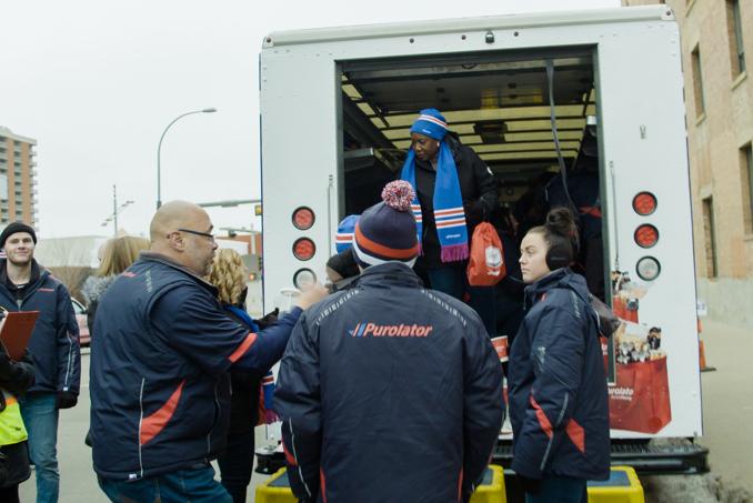 Purolator team gathered around truck