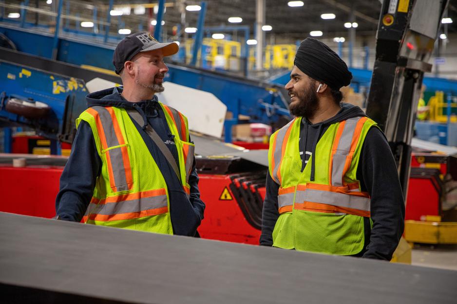 DEI - Two workers in facility